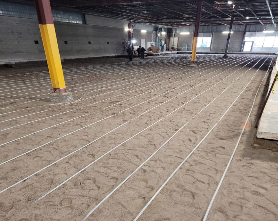 Installation of underfloor heated glycol tubing.