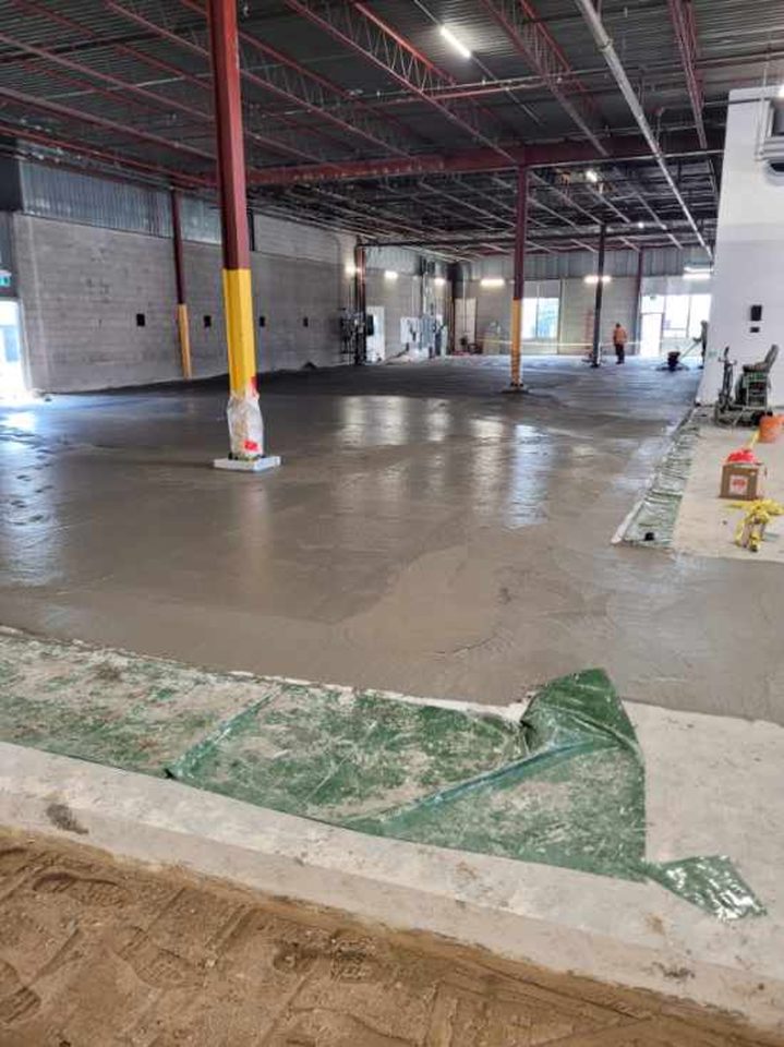 Finishing of new concrete freezer floor.