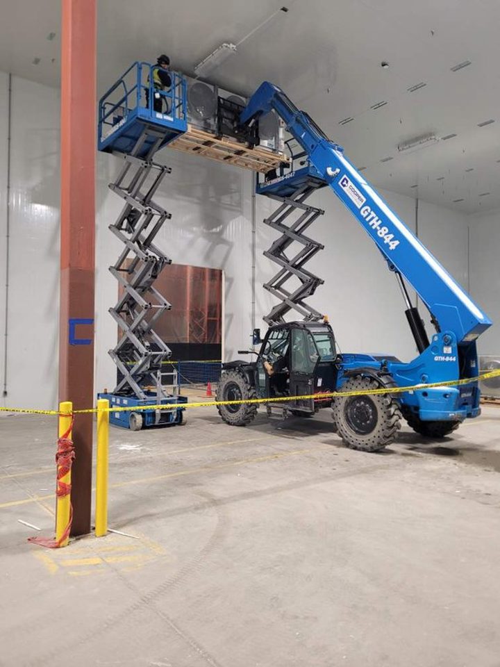 Installation of one of seventeen high profile electric defrost evaporators in the cold dock.