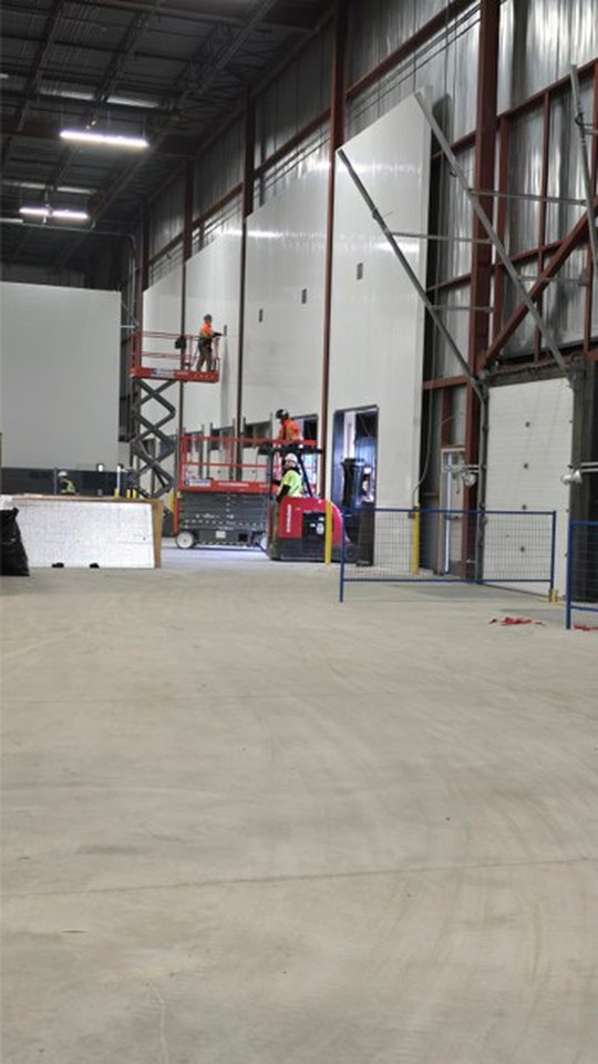 Installation of IMP walls against existing dock doors at the cold dock location.