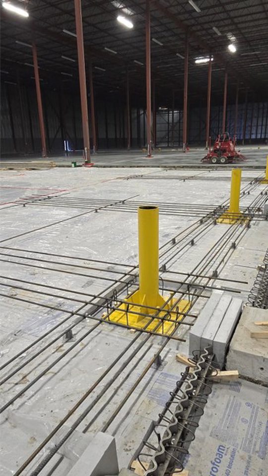 Installation of goal post style door bollards inside freezer.
