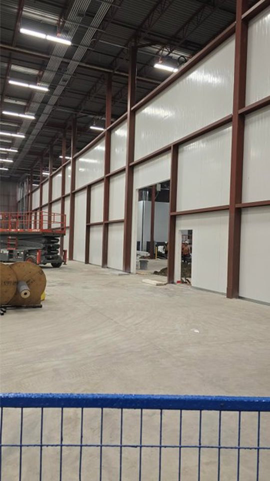 Structural reinforcement of cold dock partition wall to ambient warehouse.